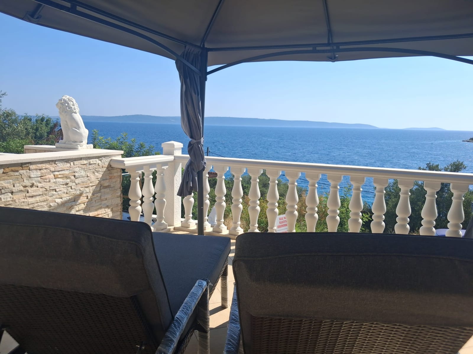 Loungebereich auf der Terrasse mit Blick auf die offene Adria